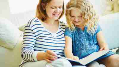 A mother and daughter reading an ADHD parenting book together