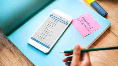 A parent with ADHD uses her phone and a calendar to manage self-care and organization.