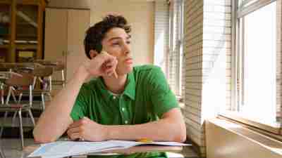 Teen with ocd and adhd looking out of a window