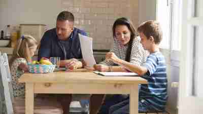Parents discussing examples of behavior therapy with their two children