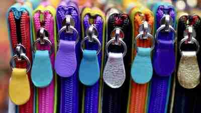 Close-up side view of colorful zippered wallets or go bags, helpful ADHD organization tools