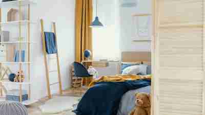 unmade bed in kid's bedroom