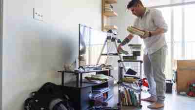 A man decluttering and organizing his belongings at home.