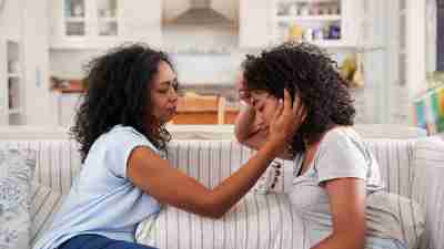 Mother comforting teen daughter