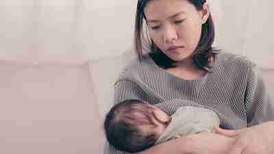 A tired mother experiencing postnatal depression