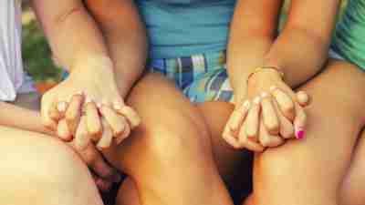 Teen girls with ADHD holding hands outside and forming friendships